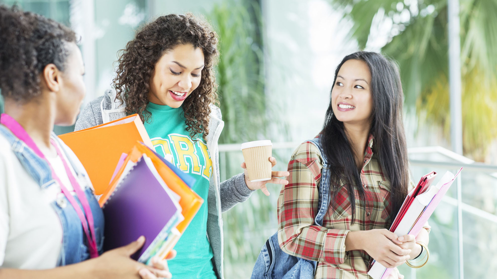 University students walking with books and coffee